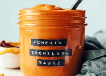 Side view of a glass jar of pumpkin enchilada sauce