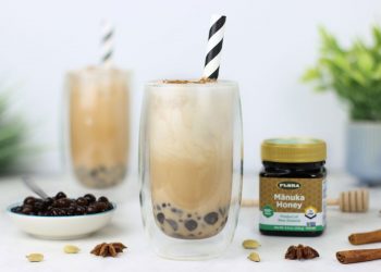 Two healthy, iced chai boba teas and a jar of Flora Manuka Honey