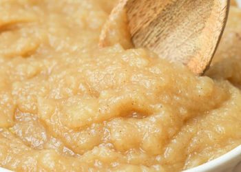homemade applesauce in a bowl with a wooden spoon