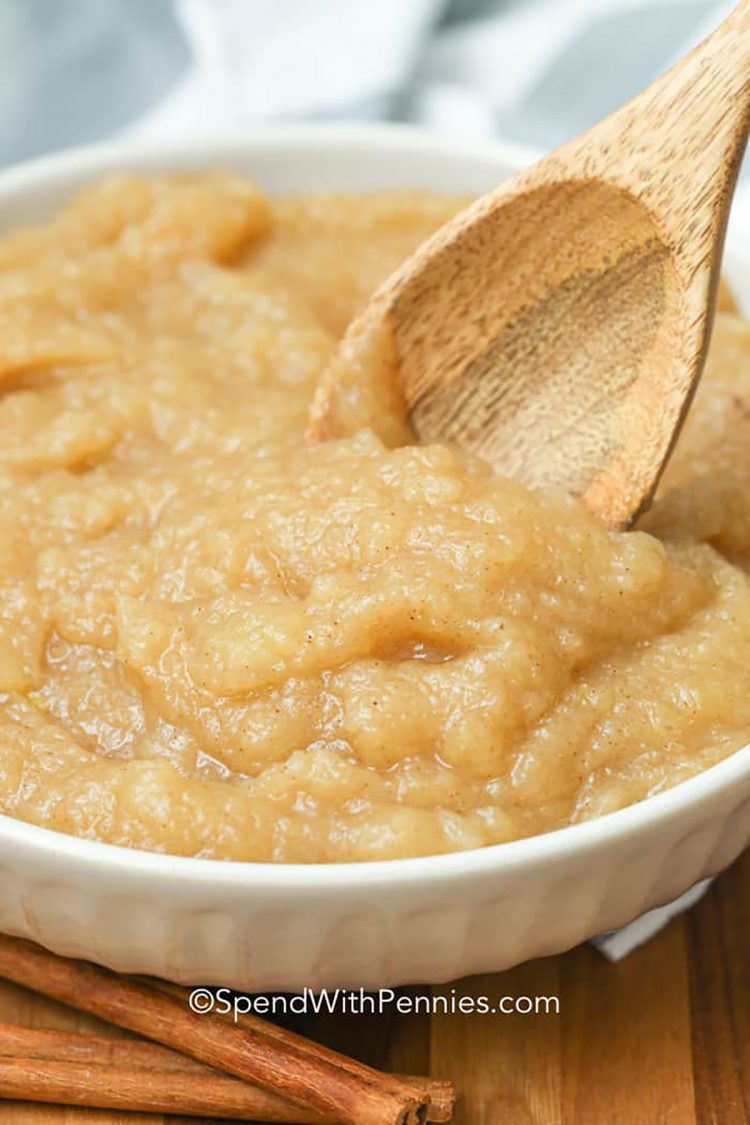 homemade applesauce in a bowl with a wooden spoon