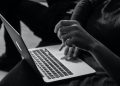 Hands in front of a laptop