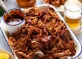 My best pulled pork in a pan with sides ready to be served