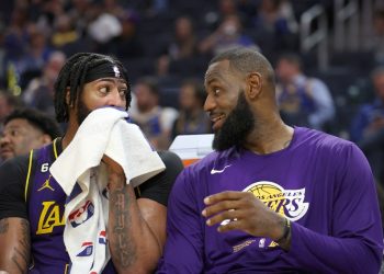 Anthony Davis #3 talks to LeBron James #6 of the Los Angeles Lakers on the bench during their game against the Golden State Warriors at Chase Center on October 18, 2022 in San Francisco, California.