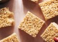 Hand grabbing cut rice krispie bars