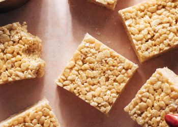 Hand grabbing cut rice krispie bars