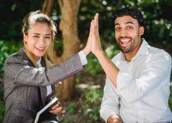 two people high fiving each other