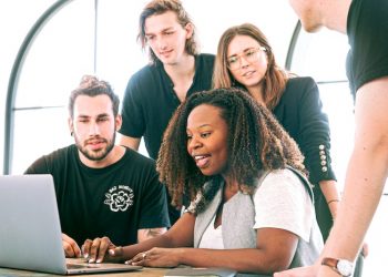 group of people looking at laptop