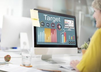 woman sitting in front of computer looking at data and graphs