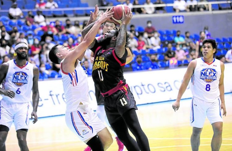 Myles Powell (left) muscles his way past Kevin Alas. He went on to torch the Road Warriors with 38 points. —PBA IMAGES