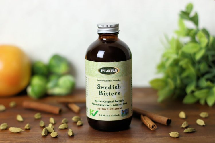 A bottle of Swedish Bitters from Flora surrounded by ingredients.