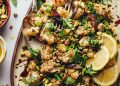 Platter of roasted cauliflower salad with pistachios, parsley, and roasted red onion